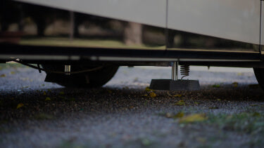 RV SnapPads lowering to concrete ground on leveling jack